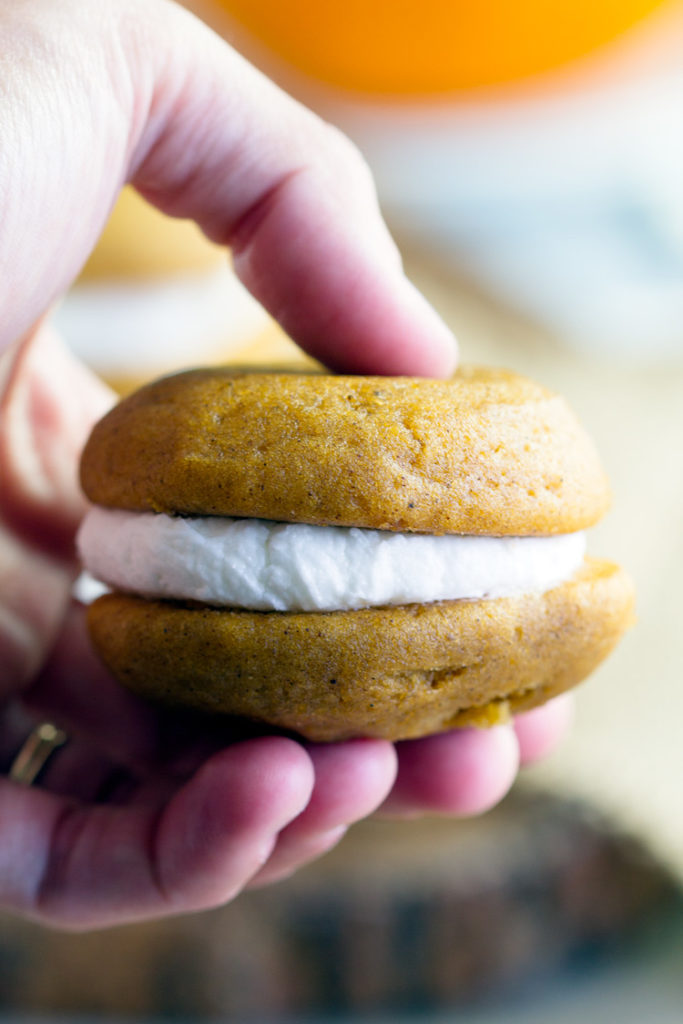 Pumpkin Whoopie Pies - Homemade Amish pumpkin whoopie pies perfect for autumn. Sandwich cookies are soft and perfect for sharing for bake sales and more. Our favorite fall treat!