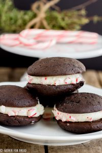 Chocolate Whoopie Pies with Peppermint Whipped Filling - Delicious Christmas inspired chocolate sandwich cookies filled with a whipped peppermint filling and rolled in crushed peppermint candy canes Perfect dessert to serve for the holidays.