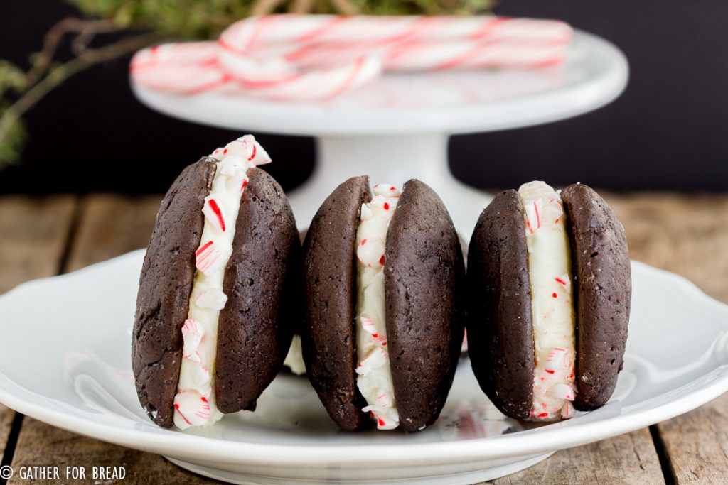 Chocolate Whoopie Pies with Peppermint Whipped Filling - Delicious Christmas inspired chocolate sandwich cookies filled with a whipped peppermint filling and rolled in crushed peppermint candy canes Perfect dessert to serve for the holidays.