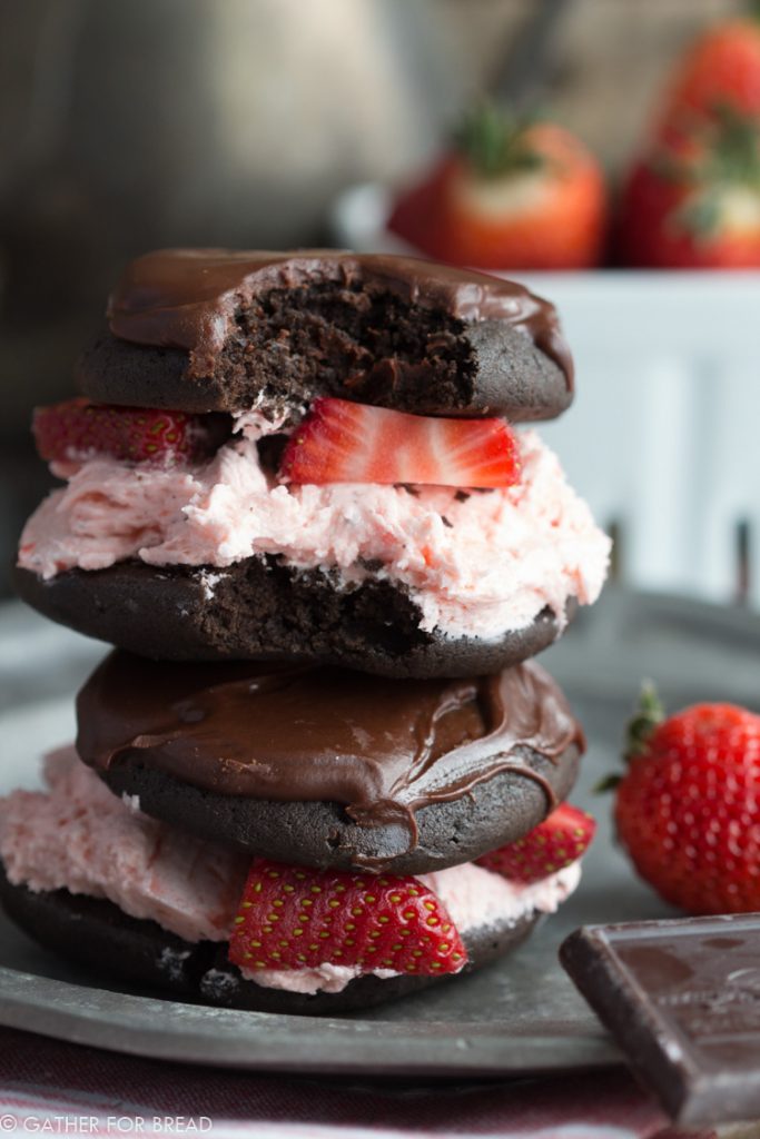Chocolate Covered Strawberry Whoopie Pies - These chocolate cookie sandwiches are made with FRESH strawberries, real jam and topped with a chocolate glaze just for FUN. Perfect for Valentine's Day treats!