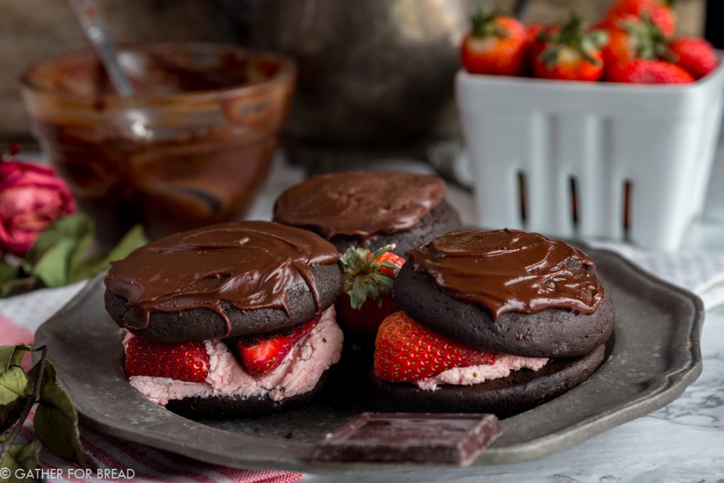 Chocolate Covered Strawberry Whoopie Pies - Chocolate cookies stuffed with fresh strawberry filling, and a chocolate ganache. Like chocolate covered strawberries and a cookie all in one! Perfect to share with your love on Valentine's or any day of the year!