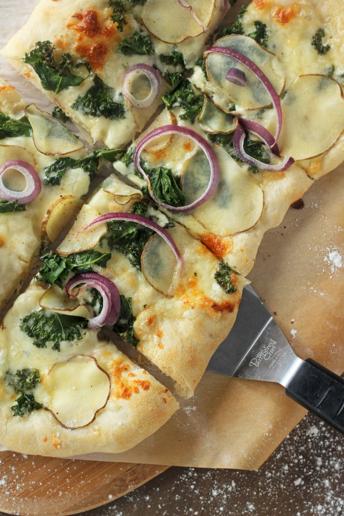  Freshly made pizza topped with thinly sliced potato, kale, red onion, a hint of garlic and delicious cheeses. One of the best pizza combo toppings ever! gatherforbread.com