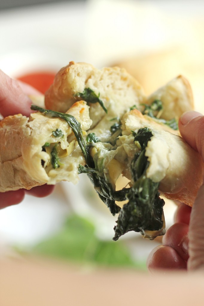 Crispy baked puffs of dough stuffed with your favorite cheesy spinach artichoke mixture.