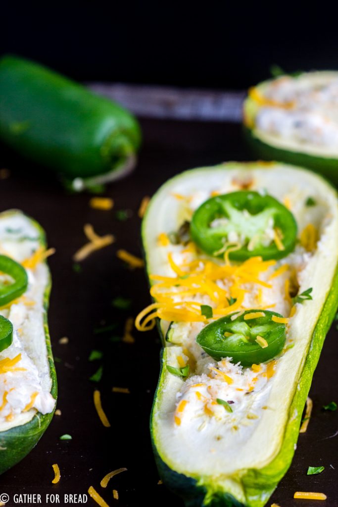 Jalapeno Popper Zucchini Boats - A fresh twist on traditional zucchini boats. They're loaded with cheese, jalapeno and have just the right pop. Perfect summer side dish.