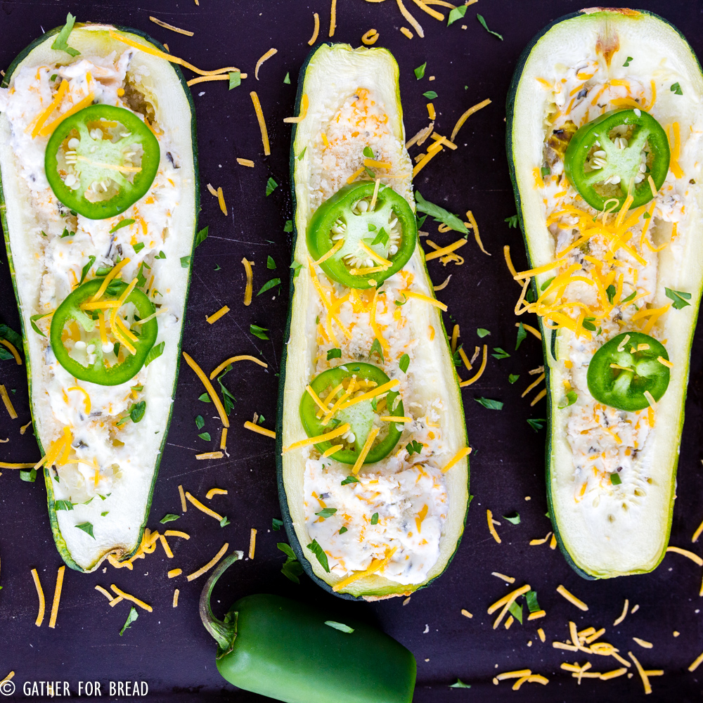 Jalapeno Popper Zucchini Boats - A fresh twist on traditional zucchini boats. They're loaded with cheese, jalapeno and have just the right pop. Perfect summer side dish.