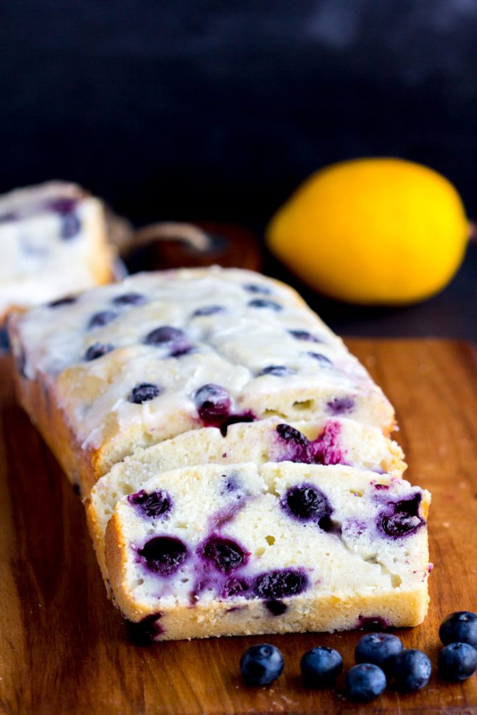Lemon Blueberry Yogurt Bread - AMAZING Homemade moist lemon bread with fresh blueberries with a lemon glaze!! Greek yogurt makes this loaf a great quick bread to serve in the spring or summer.