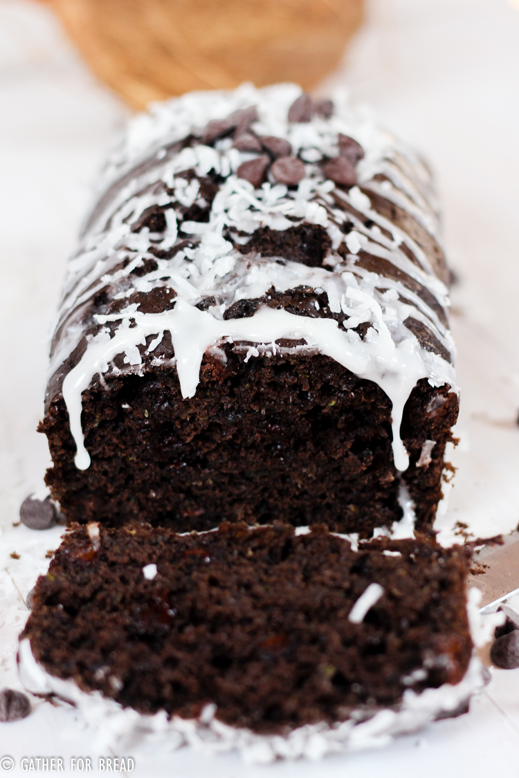 Dark Chocolate Zucchini Bread with Coconut Glaze - Recipe for moist chocolate zucchini quick bread topped with a coconut glaze. The recipe makes a sweet homeade loaf that's perfect for summer.