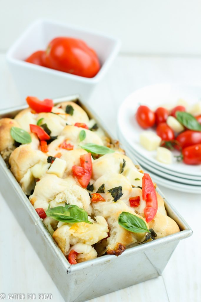 Pull Apart Caprese Bread - Pull apart bread yeast topped with delicious fresh tomatoes, mozzarella, and basil. Homemade dough, makes a great appetizer or starter.