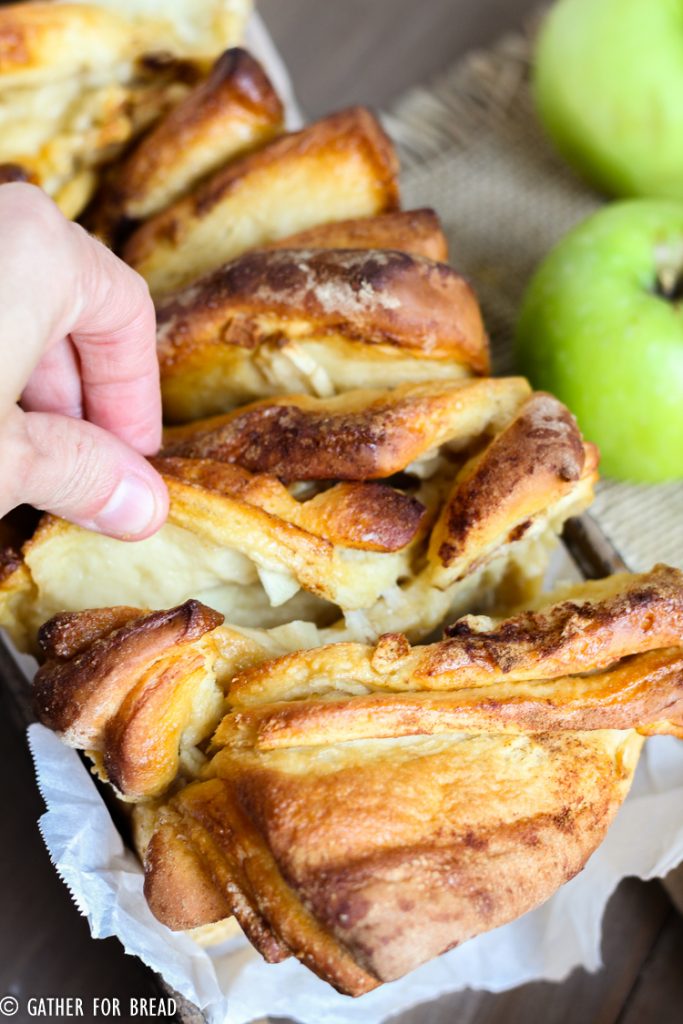 Apple cinnamon pull apart bread. Layers of homemade dough with chunks of real apple and cinnmon baked into this delicious pull apart loaf. Perfect for fall parties as an appetizer or dessert.