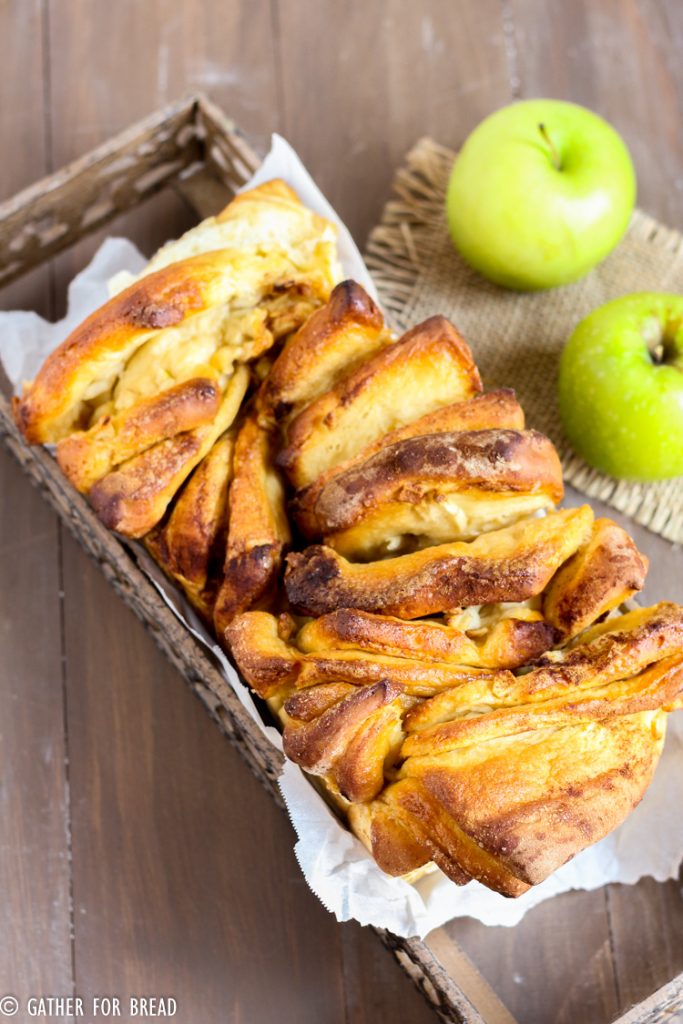Apple cinnamon pull apart bread. Layers of homemade dough with chunks of real apple and cinnmon baked into this delicious pull apart loaf. Perfect for fall parties as an appetizer or dessert.