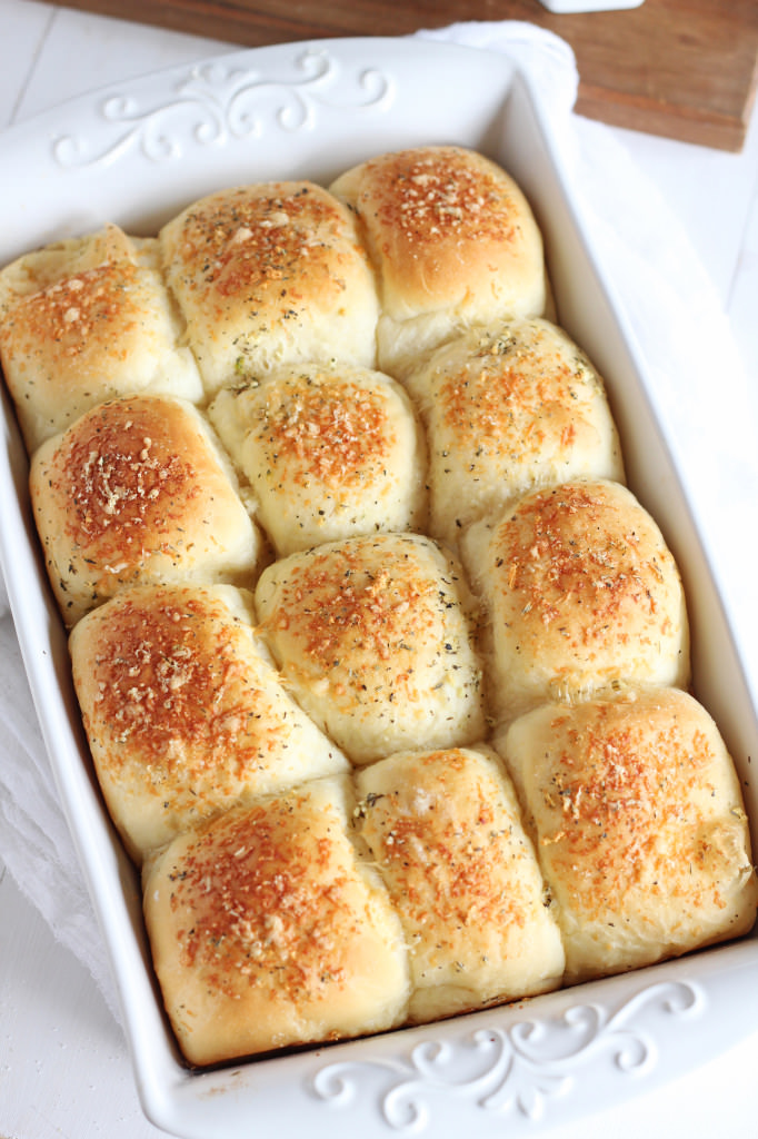 Buttery Parmesan Garlic Rolls -- Simple fluffy rolls topped with butter and Parmsesan and a hint of garlic. | gatherforbread.com