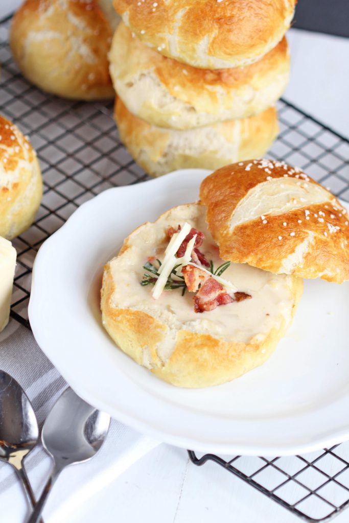 Crusty Pretzel Bread Bowls are perfect for your favorite soup, like potato cheddar cheese beer soup. YUM!