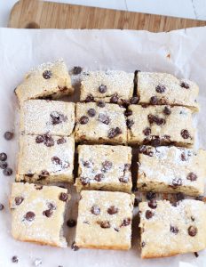 Skinny Banana Chocolate Chip Snack Bars - Amazing snack bars made lighter with Greek yogurt. Fabulous recipe whips up in just a few minutes. Perfect for ripened bananas!