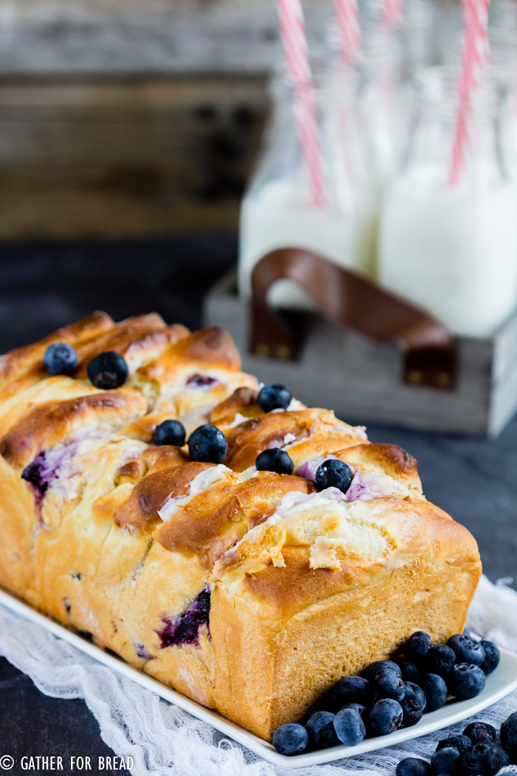 Delicious homemade pull apart bread is made with homemade dough, stuffed with cream cheese and studded with fresh blueberries. A summer favorite for berry lovers