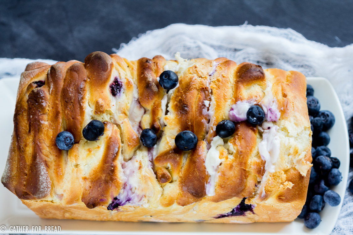 Delicious homemade pull apart bread is made with homemade dough, stuffed with cream cheese and studded with fresh blueberries. A summer favorite for berry lovers