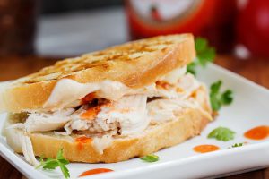 Buffalo Chicken Grilled Cheese - This grilled cheese sandwich bread is stuffed with melty cheese, rotisserie chicken smothered with hot sauce for the ultimate buffalo chicken sandwich.