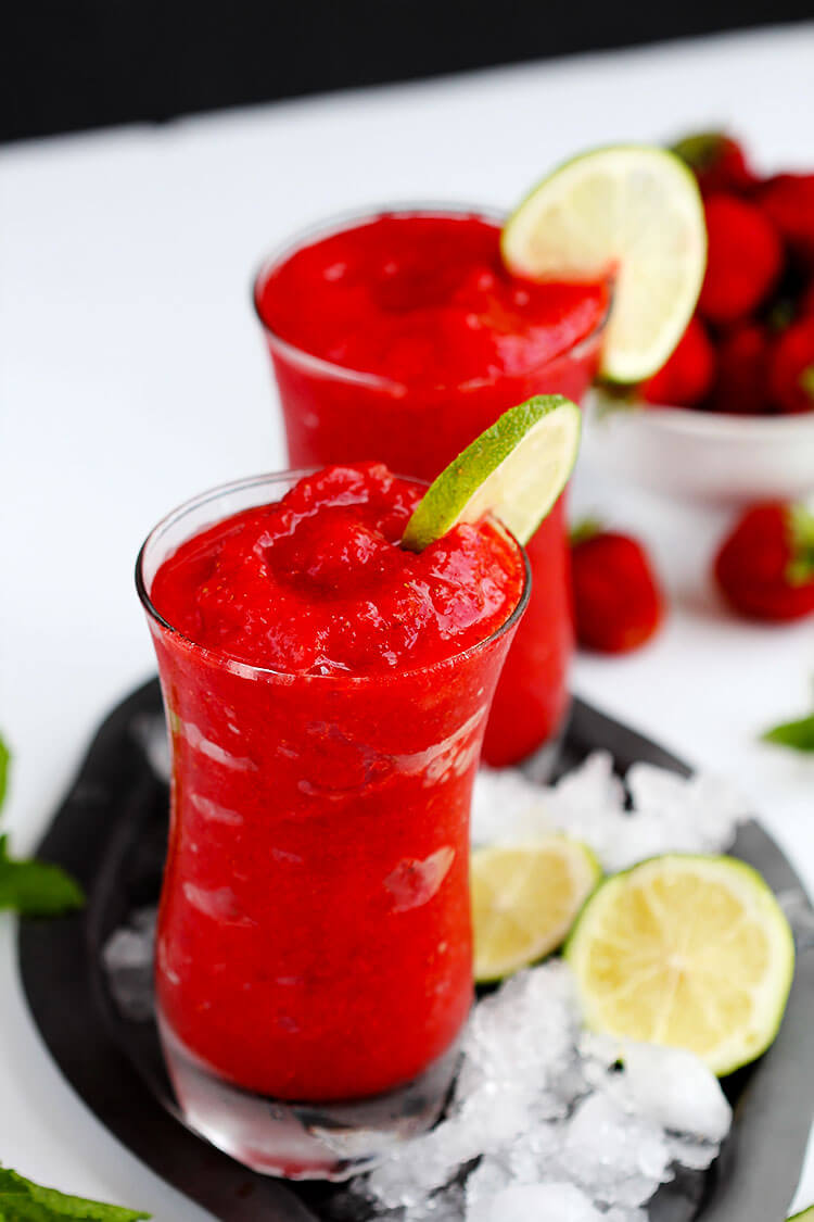 Strawberry Lime Slush - Fruit slushies are the perfect summer drink. Made with real fruit these are easy to make at home and you'll be sipping this icee drink in minutes.