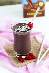 Chocolate Raspberry Smoothie - Delicious blend of frozen raspberries, cocoa, almond milk for a smooth, creamy kick start for your day. Top with fresh berries, coconut and chocolate.
