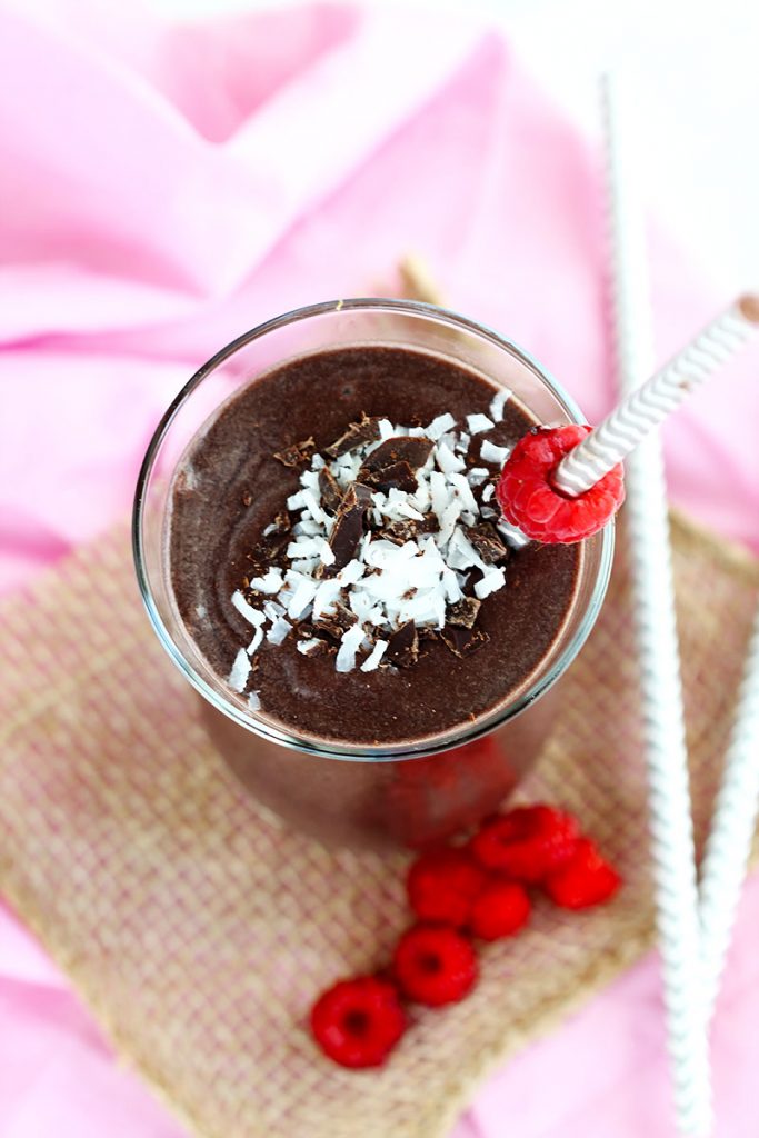 Chocolate Raspberry Smoothie - Delicious blend of frozen raspberries, cocoa, almond milk for a smooth, creamy kick start for your day. Top with fresh berries, coconut and chocolate.