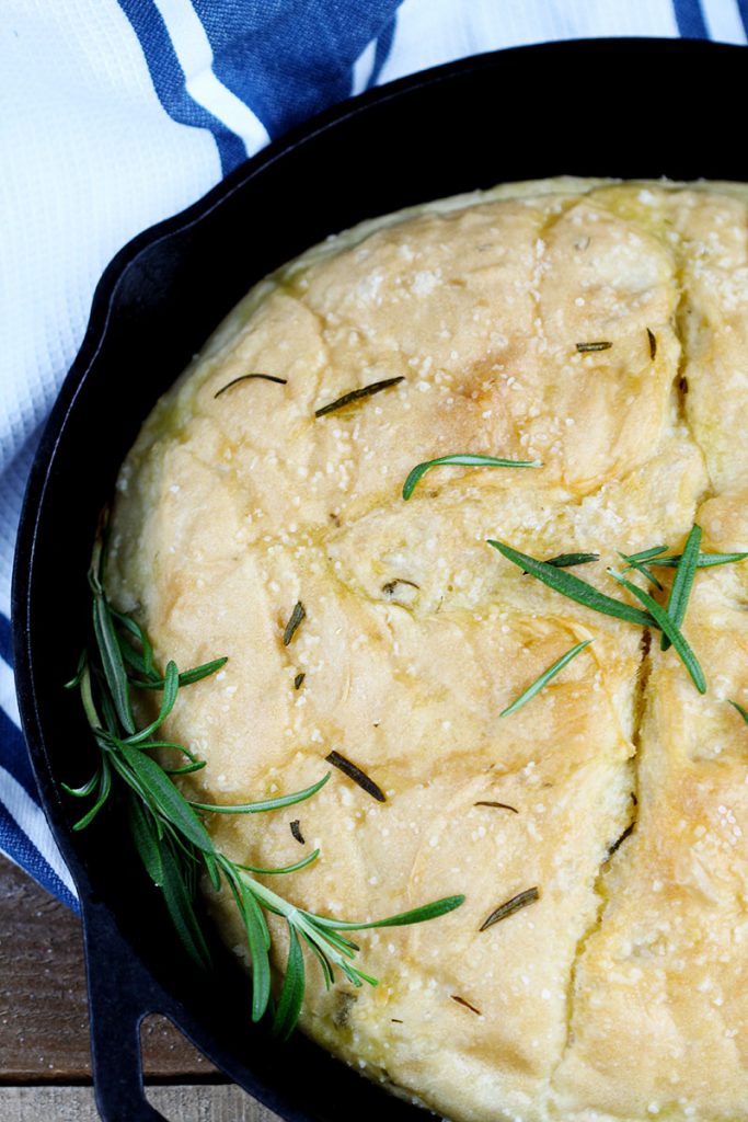 Rosemary No Knead Skillet Bread - Delicious and easy, this loaf bakes up quickly. Fresh, simple - olive oil, rosemary and seasoning for the perfect rise yeast bread in a skillet.