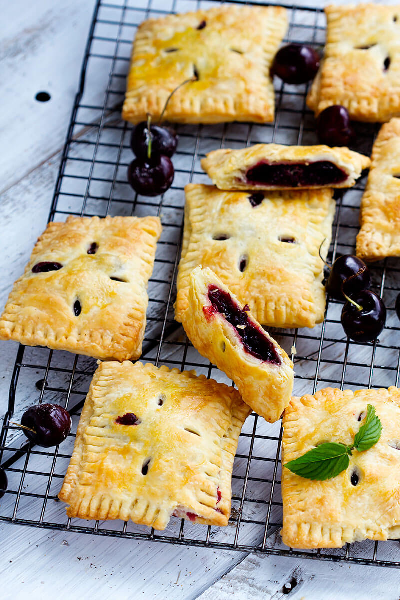 Sweet Cherry Hand Pies - Handheld cherry pies made with sweet fresh cherries. All whole ingredients, made with real dough, make a perfect summer dessert that's easy to share and great for hands.