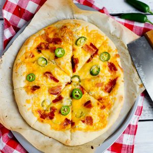 Jalapeno Popper Pizza - Fresh pizza dough topped with cream cheese, mozzarella, colby jack cheeses, fresh jalapenos and crispy bacon. Spicy family favorite for dinner.