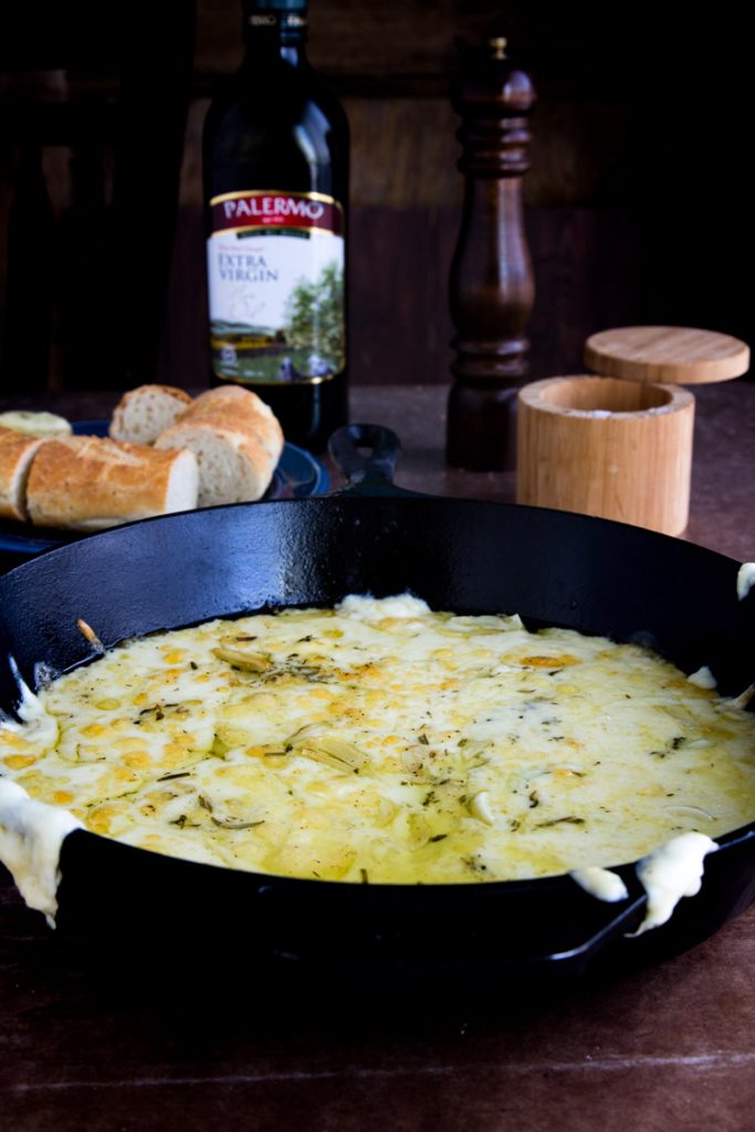 Baked Fontina Cheese Dip - Savory baked fontina, delicious blend of cheese, olive oil and herbs, paired with french baguettes for a perfect quick appetizer that's sure to be a favorite!