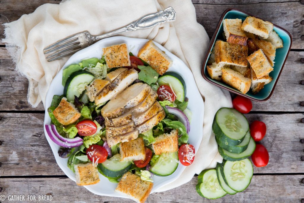 Chicken Panzanella Salad - Homemade sourdough bread cubes toasted to perfection topped on a bed of lettuces and vegetables with grilled chicken. Homemade vinaigrette, this makes the perfect lunch.