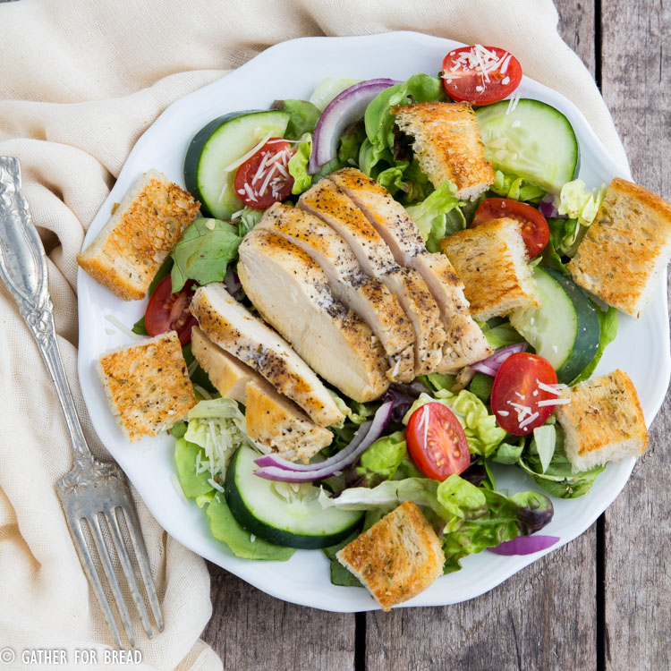 Chicken Panzanella Salad - Homemade sourdough bread cubes toasted to perfection topped on a bed of lettuces and vegetables with grilled chicken. Homemade vinaigrette, this makes the perfect lunch.