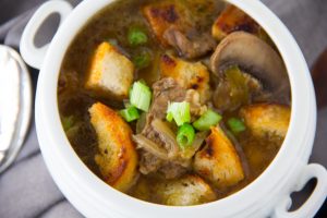 Philly Cheesesteak Soup - Homemade Philly Cheesesteak soup combines tender flank steak with onion, green pepper, mushrooms, provolone cheese, beef bone broth and crunchy homemade croutons.