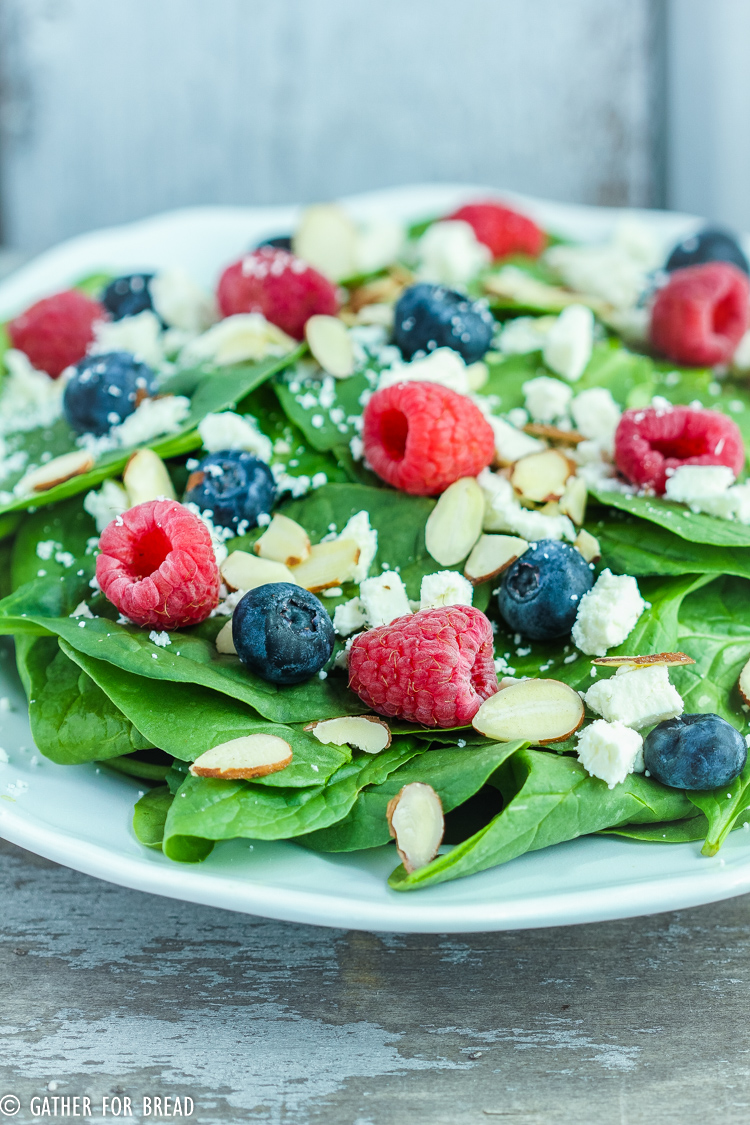 Berry Spinach Salad with Homemade Raspberry Vinaigrette - Green spinach salad recipe topped with berries and the BEST homemade raspberry vinaigrette; feta cheese, almonds with raspberries, blueberries.