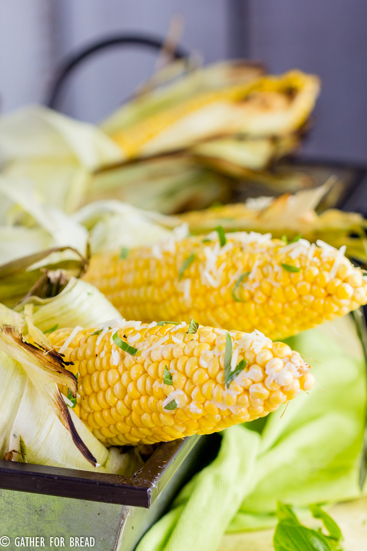 Grilled Corn on the Cob - How to Grill Corn - Grilling corn is an easy BBQ side dish recipe for summer. This corn is grilled to perfection and topped with butter, basil, and Parmesan cheese.