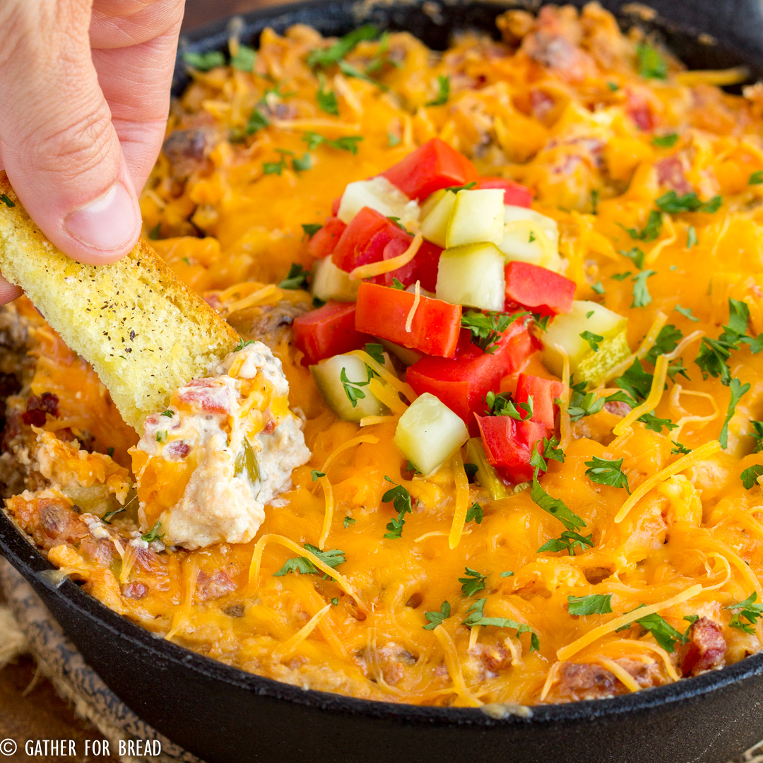 Easy Cheeseburger Dip - Ground beef mixed with cream cheese and cheddar cheese for a flavor burst of a cheeseburger in easy to make appetizer. Serve with hamburger bun dippers or your favorite cracker of tortilla chip.