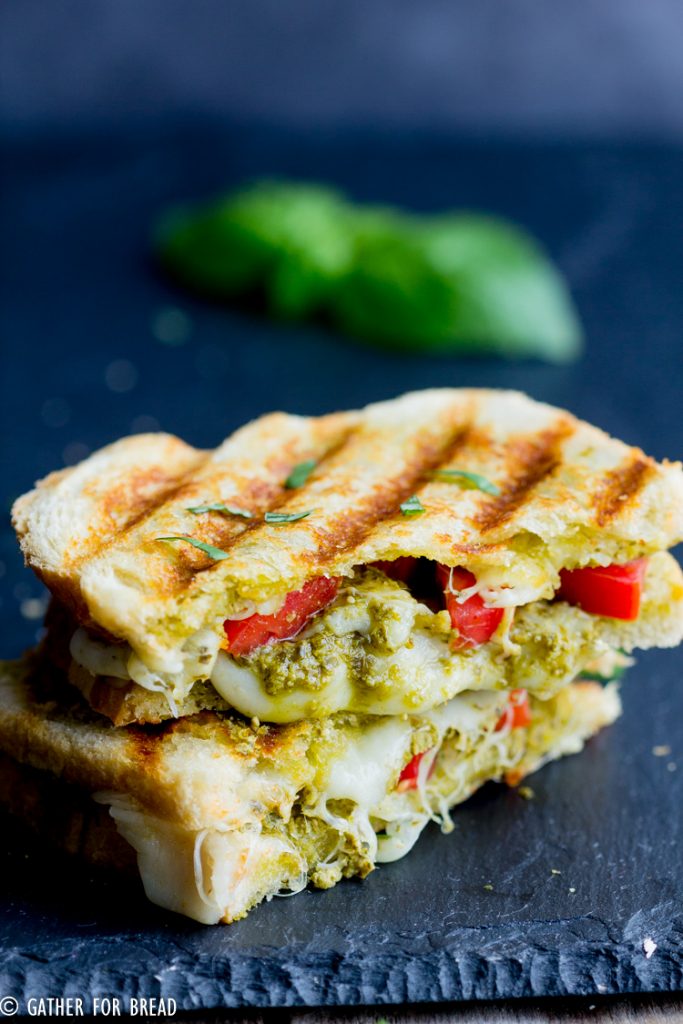 Pesto Grilled Cheese - Your favorite sandwich bread slathered with pesto, fresh tomatoes and grilled to perfection. This easy gourmet grilled cheese may be your new favorite lunch.