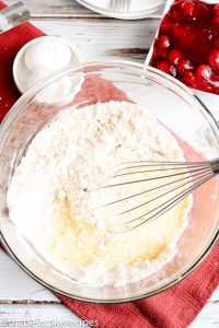 Cherry Coffee Cake - Homemade cake batter uses cherry pie filling for a quick and easy Cherry Coffee Cake that makes a delicious breakfast or dessert. Save part of the crust mixture to sprinkle on top for a yummy sugar streusel.